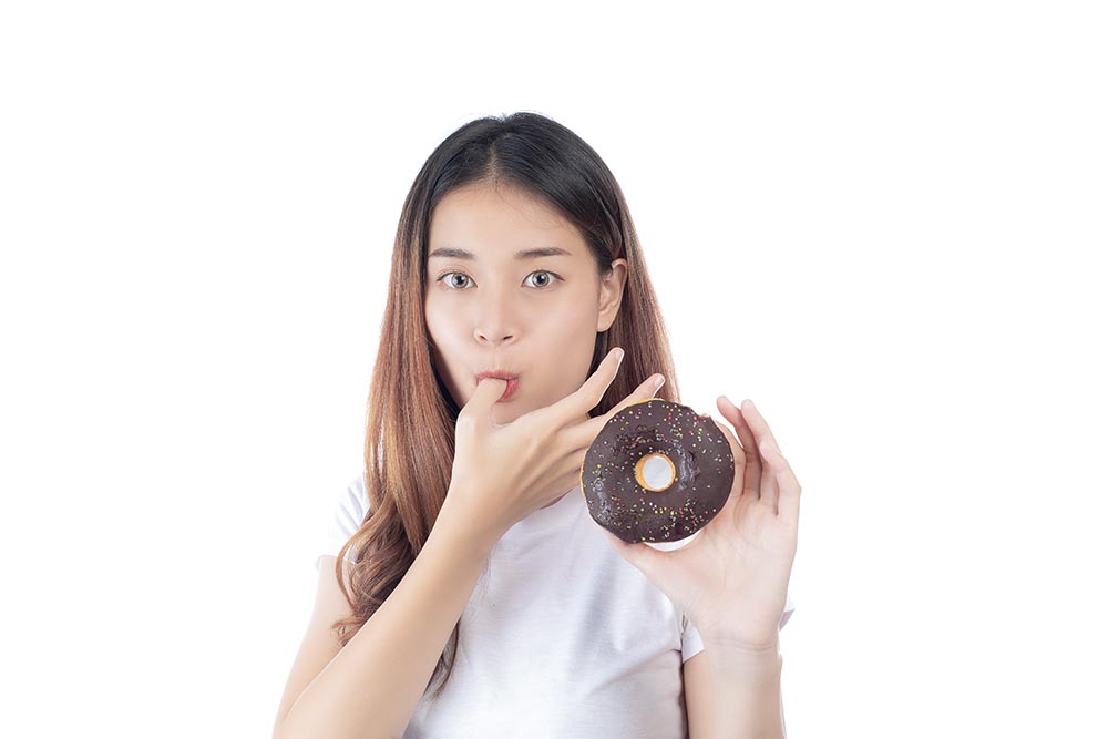 beautiful woman with happy smile holding hand donut isolated white background