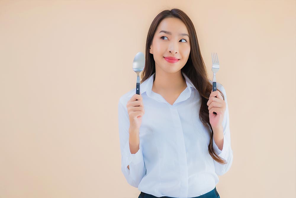 Portrait beautiful young asian business woman with spoon and for